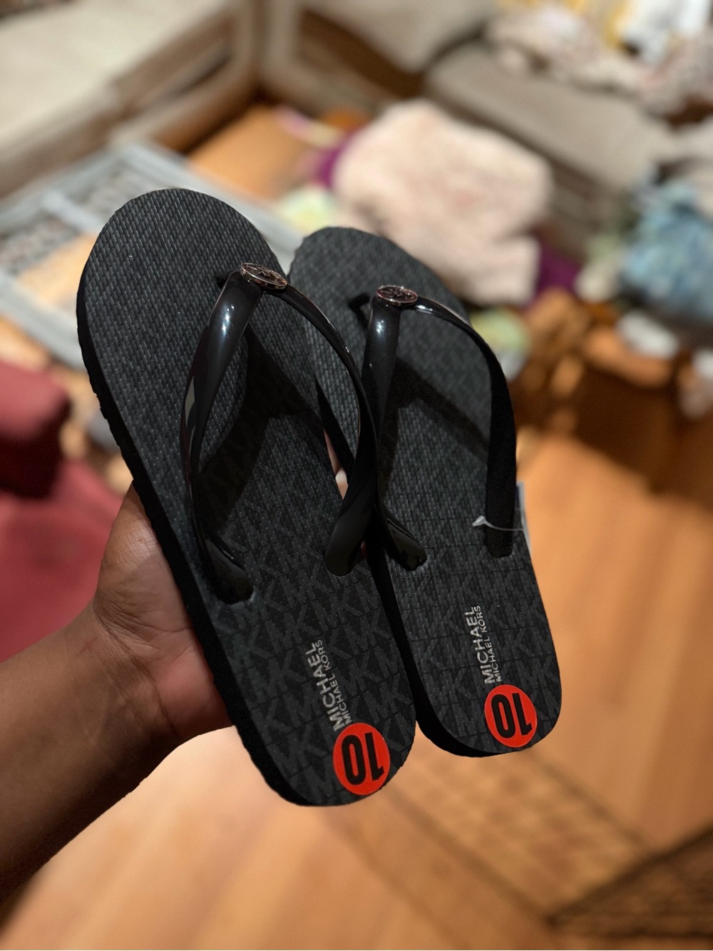 MICHAEL Michael Kors Black Logo Pattern Flip Flops with Red Size Accent